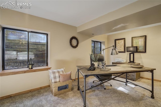 carpeted office space featuring baseboards