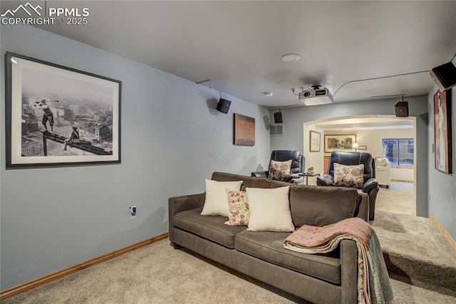 carpeted living room with baseboards