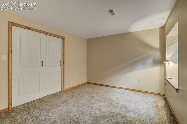 interior space with light colored carpet, visible vents, and baseboards