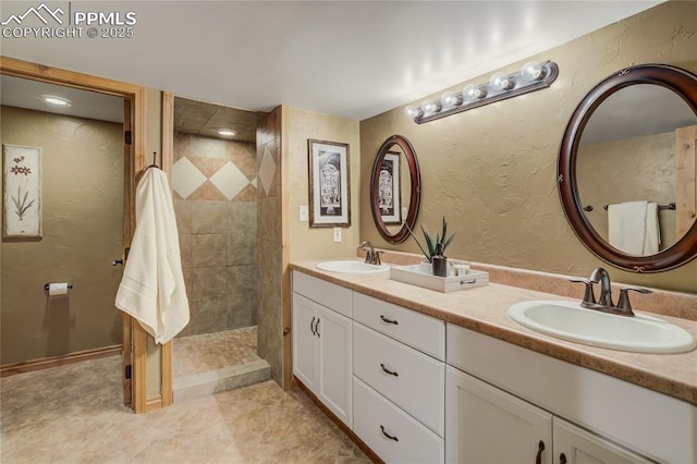 bathroom featuring a textured wall and a sink