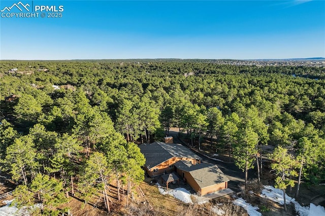 aerial view featuring a wooded view