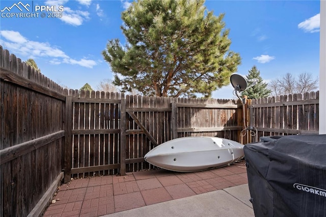 view of patio / terrace featuring grilling area and fence