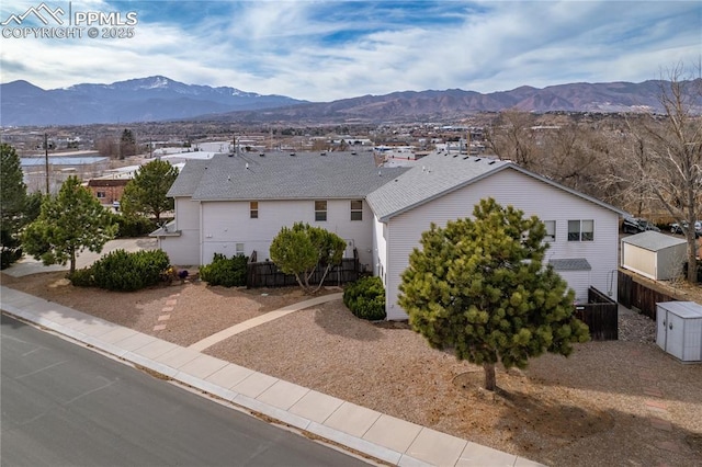 exterior space with a mountain view and fence