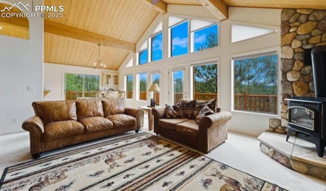 living room featuring beamed ceiling, wood ceiling, carpet flooring, a wood stove, and high vaulted ceiling