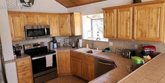 kitchen with tasteful backsplash, tile countertops, wooden ceiling, stainless steel appliances, and a sink