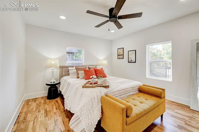 bedroom with recessed lighting, light wood-style floors, and baseboards