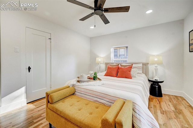 bedroom featuring recessed lighting, baseboards, wood finished floors, and a ceiling fan