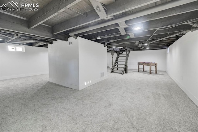 basement featuring stairway, carpet flooring, baseboards, and visible vents