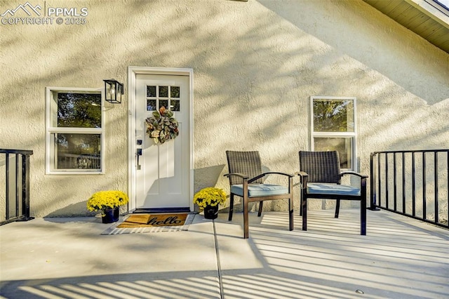 property entrance featuring stucco siding