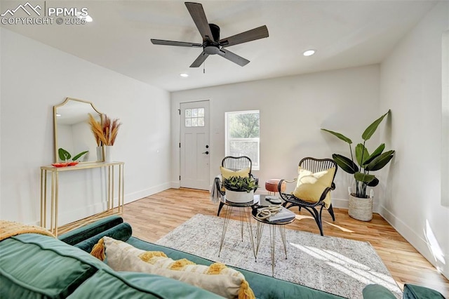 living area with recessed lighting, baseboards, wood finished floors, and ceiling fan