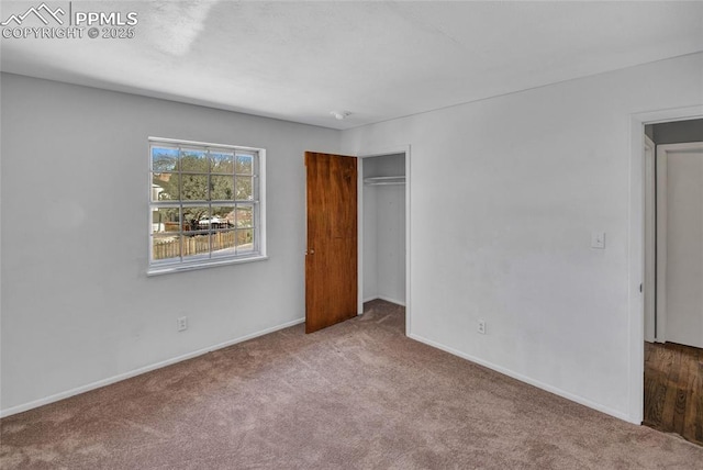 unfurnished bedroom featuring baseboards, a closet, and carpet floors