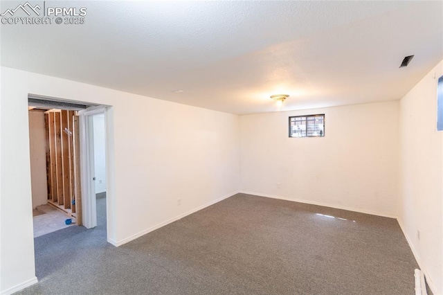 basement featuring baseboards and carpet flooring
