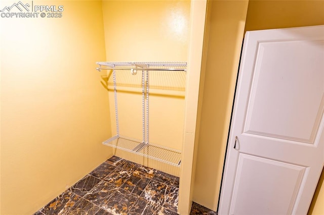 spacious closet featuring marble finish floor