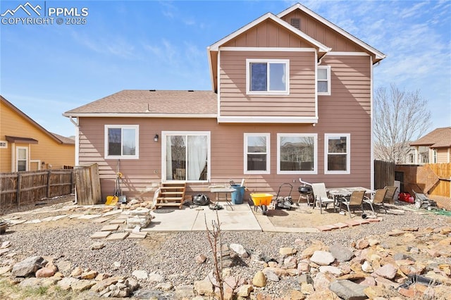 rear view of property with board and batten siding, a patio, a fenced backyard, and entry steps