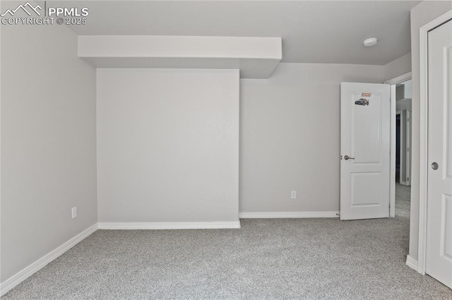 carpeted empty room with baseboards