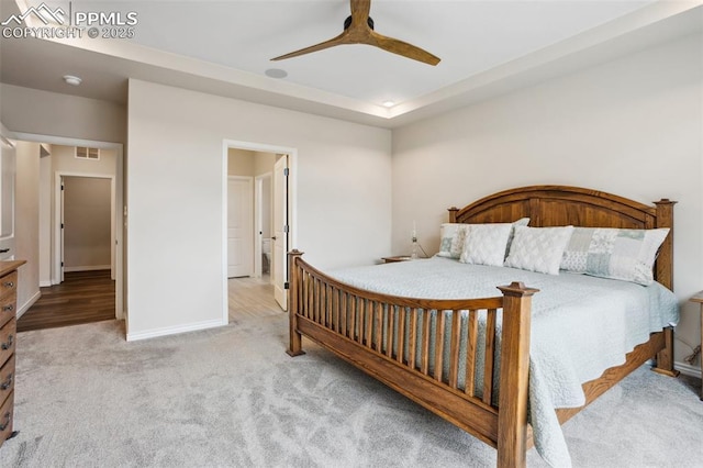 6001 Bennach Grv, Colorado Springs, CO 80927 - bedroom with visible vents, a tray ceiling, carpet flooring, baseboards, and ceiling fan