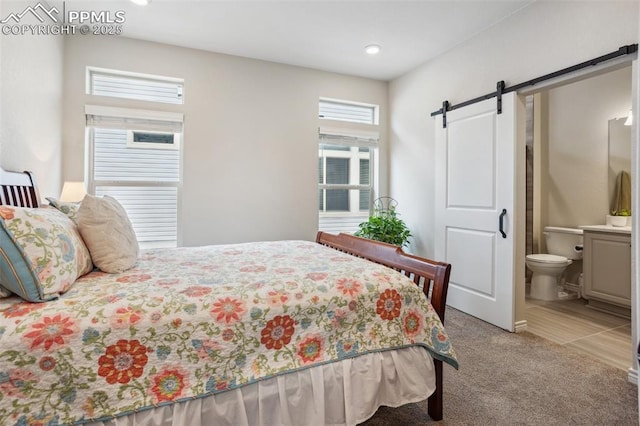 6001 Bennach Grv, Colorado Springs, CO 80927 - carpeted bedroom featuring connected bathroom and a barn door