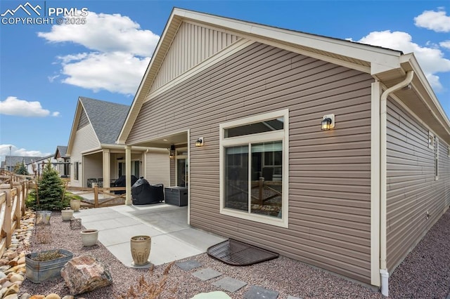 6001 Bennach Grv, Colorado Springs, CO 80927 - back of house featuring board and batten siding, a patio, and fence