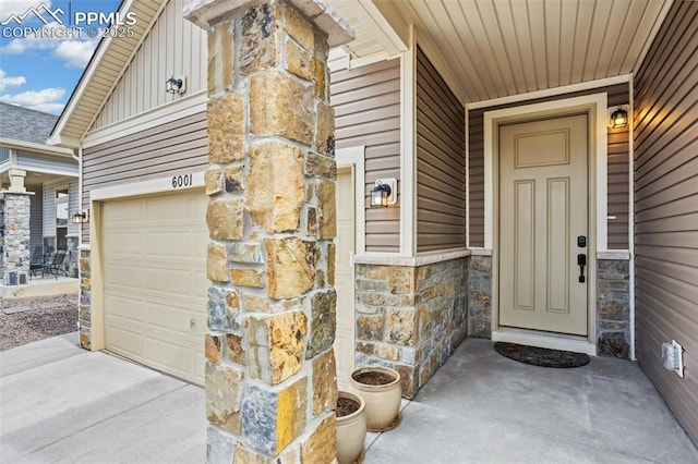 6001 Bennach Grv, Colorado Springs, CO 80927 - entrance to property featuring stone siding, board and batten siding, driveway, and a garage