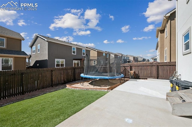 8040 Barraport Dr, Colorado Springs, CO 80908 - view of yard with a fenced backyard, a residential view, a patio area, and a trampoline