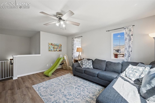 8040 Barraport Dr, Colorado Springs, CO 80908 - living room with baseboards, wood finished floors, ceiling fan, and a healthy amount of sunlight