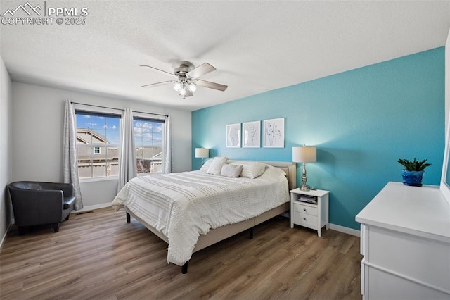 8040 Barraport Dr, Colorado Springs, CO 80908 - bedroom featuring a textured ceiling, baseboards, ceiling fan, and wood finished floors