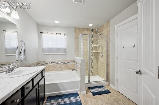 8040 Barraport Dr, Colorado Springs, CO 80908 - bathroom featuring a shower stall, vanity, a bath, and tile patterned flooring