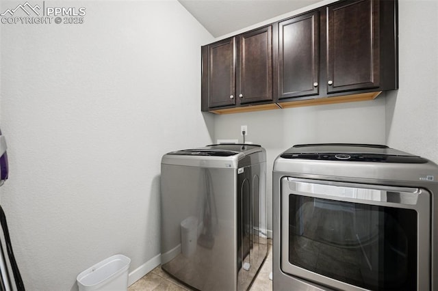 8040 Barraport Dr, Colorado Springs, CO 80908 - laundry area with light tile patterned floors, cabinet space, washing machine and dryer, and baseboards