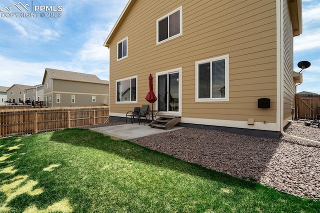 back of property featuring entry steps, a lawn, a fenced backyard, and a patio