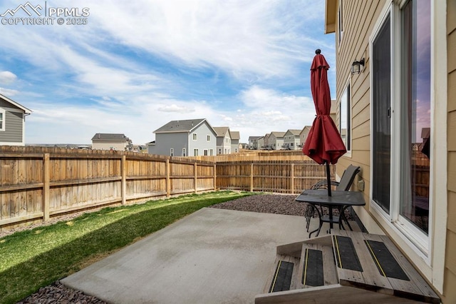 view of patio / terrace featuring a fenced backyard and a residential view