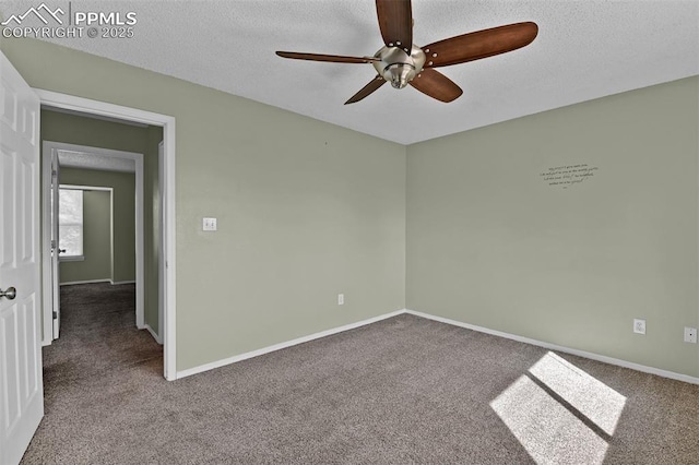 carpeted empty room featuring baseboards, a textured ceiling, and a ceiling fan