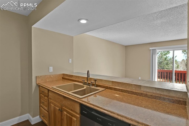 kitchen with brown cabinetry, baseboards, a sink, a textured ceiling, and stainless steel dishwasher