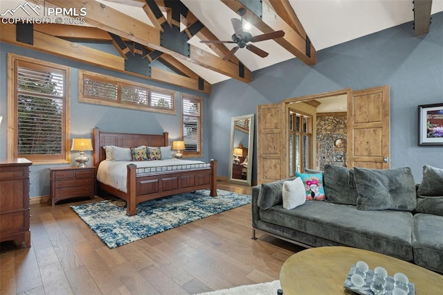 bedroom featuring high vaulted ceiling, hardwood / wood-style flooring, beamed ceiling, and baseboards