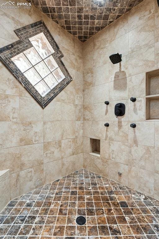 bathroom with a tile shower