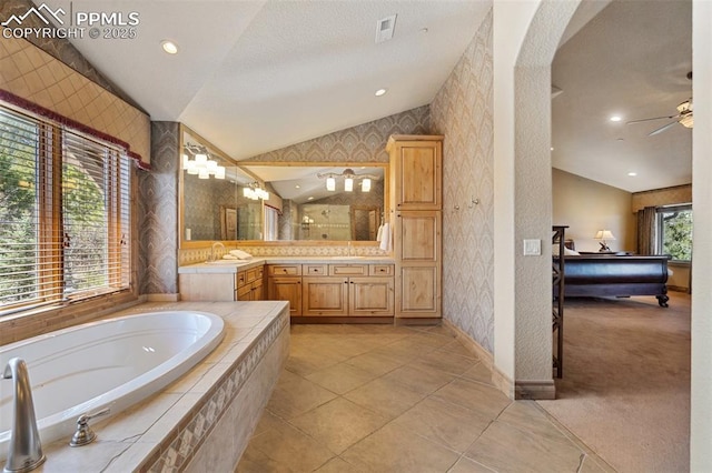 bathroom with wallpapered walls, a stall shower, and vaulted ceiling