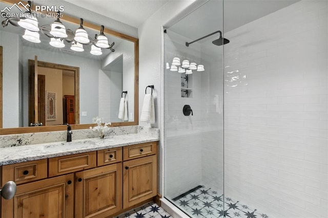 bathroom with vanity and a tile shower