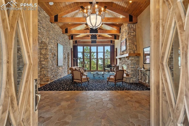 unfurnished room with a notable chandelier, beam ceiling, wood ceiling, and stone flooring