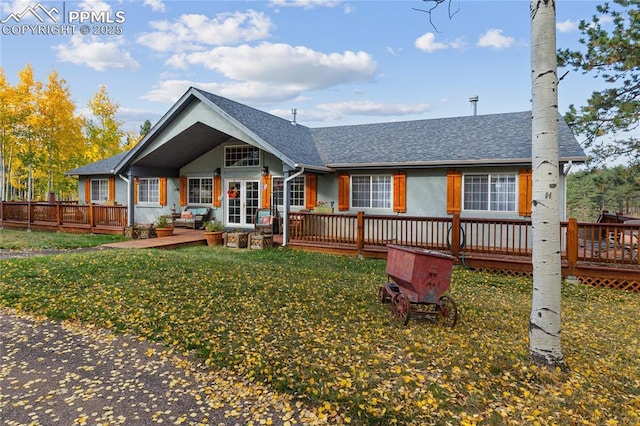 266 University Dr, Woodland Park, CO 80863 - back of property featuring a deck, a lawn, and roof with shingles