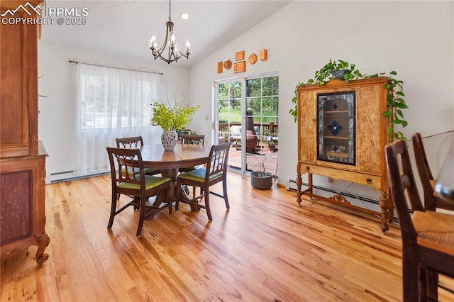 266 University Dr, Woodland Park, CO 80863 - dining area with light wood-style flooring, lofted ceiling, and an inviting chandelier