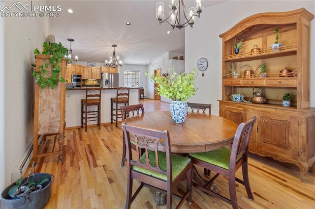 266 University Dr, Woodland Park, CO 80863 - dining room with recessed lighting, a baseboard radiator, light wood-style floors, and a chandelier