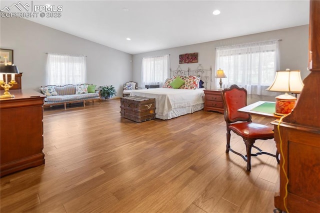 266 University Dr, Woodland Park, CO 80863 - bedroom featuring recessed lighting, vaulted ceiling, multiple windows, and wood finished floors