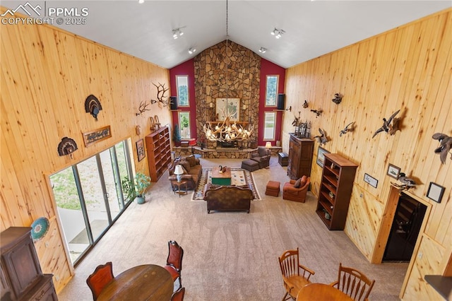 266 University Dr, Woodland Park, CO 80863 - interior space with carpet flooring, a stone fireplace, and wooden walls