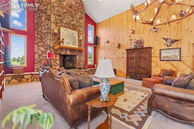 266 University Dr, Woodland Park, CO 80863 - living area with carpet flooring, plenty of natural light, wood walls, and high vaulted ceiling