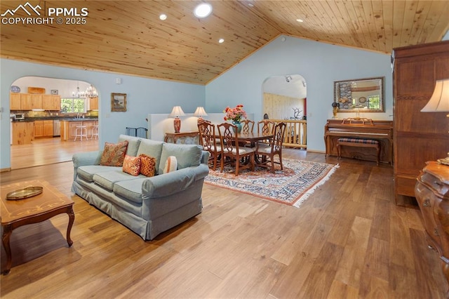 266 University Dr, Woodland Park, CO 80863 - living area featuring arched walkways, wood ceiling, a chandelier, and light wood finished floors