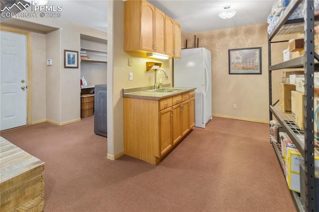 266 University Dr, Woodland Park, CO 80863 - kitchen featuring carpet floors, baseboards, freestanding refrigerator, and a sink