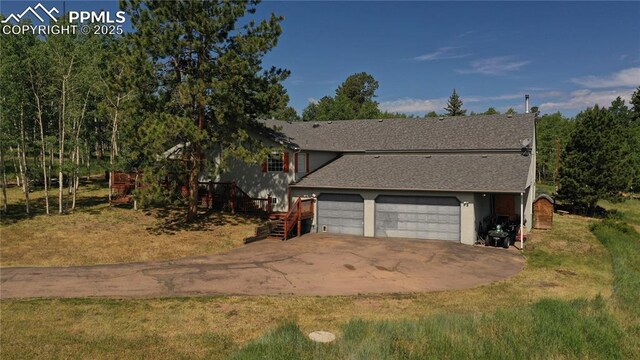 266 University Dr, Woodland Park, CO 80863 - exterior space with roof with shingles, concrete driveway, and an attached garage