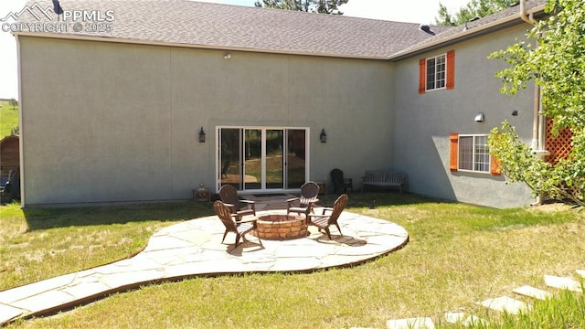 266 University Dr, Woodland Park, CO 80863 - rear view of house featuring stucco siding, a patio, a lawn, and an outdoor fire pit