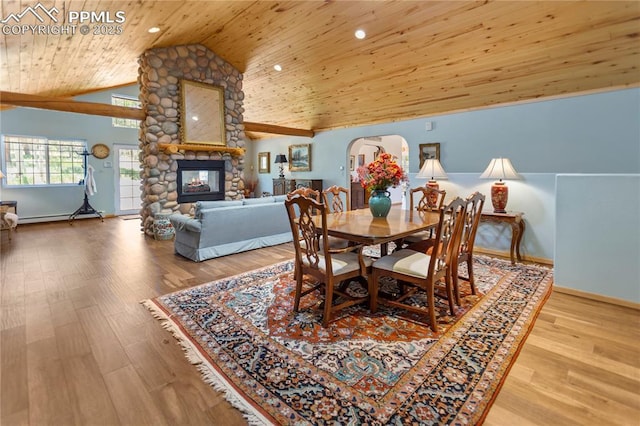 266 University Dr, Woodland Park, CO 80863 - dining room with wood finished floors, high vaulted ceiling, a fireplace, arched walkways, and wood ceiling