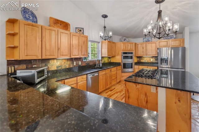 266 University Dr, Woodland Park, CO 80863 - kitchen featuring lofted ceiling, decorative backsplash, an inviting chandelier, stainless steel appliances, and open shelves