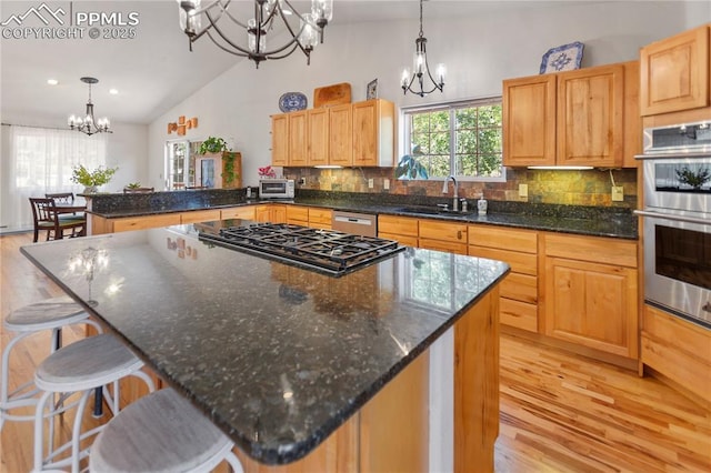 266 University Dr, Woodland Park, CO 80863 - kitchen with a notable chandelier, a sink, tasteful backsplash, double oven, and a peninsula